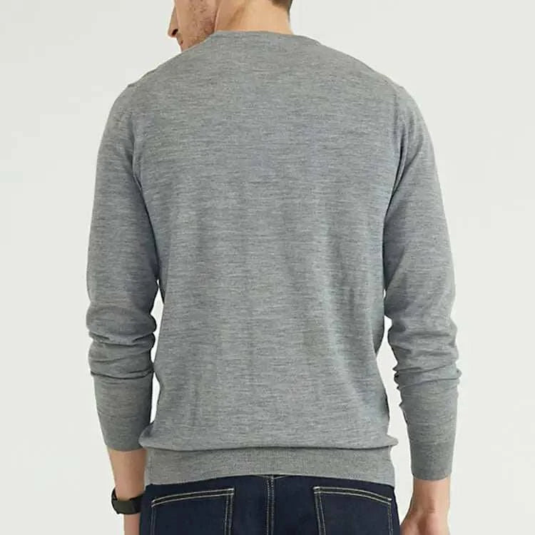 Person wearing a gray long-sleeve shirt on a white background